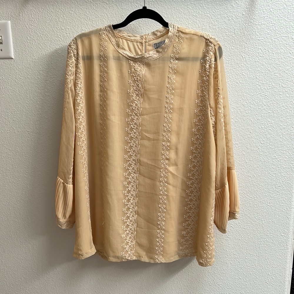 Three quarter sleeve blouse. More peach color than cream.